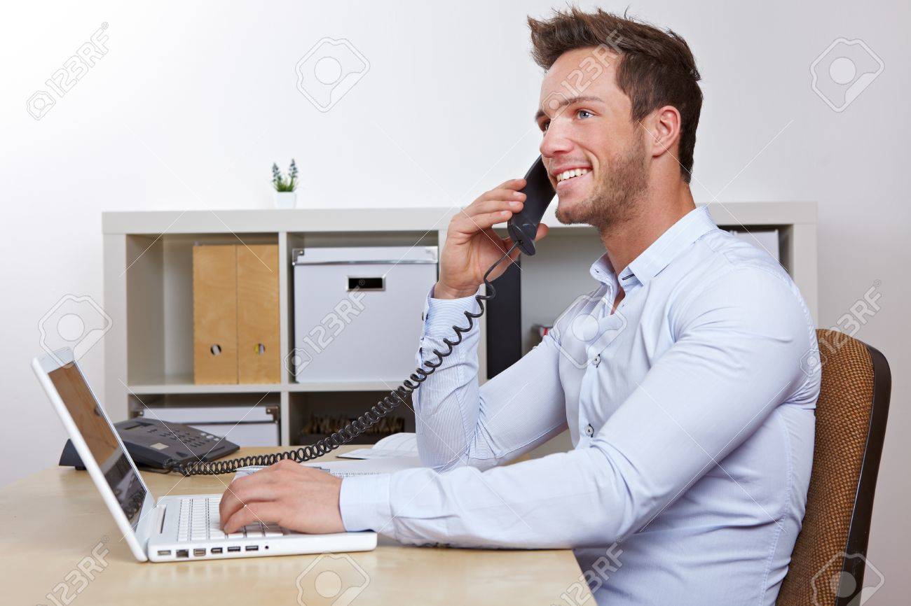 Happy Business Man With Laptop Computer In Office Making Phone.. Stock  Photo, Picture And Royalty Free Image. Image 12361557.